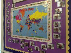 a bulletin board with pictures of people around the world on it and pinned to the wall