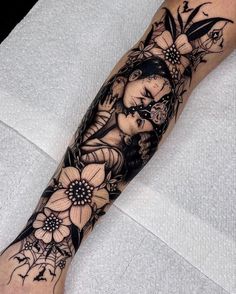 a woman's arm with flowers and butterflies on it