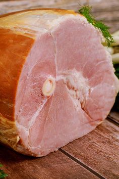 raw meat sitting on top of a wooden cutting board