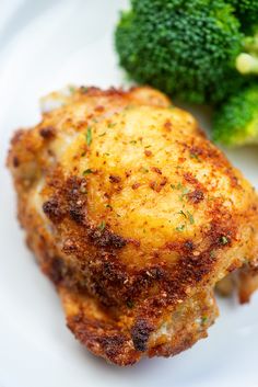 a close up of a plate of food with broccoli and chicken on it