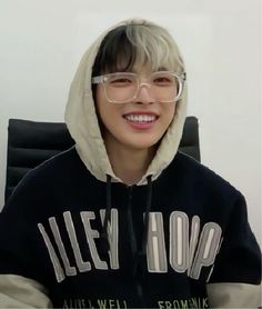 a person wearing glasses and a hoodie