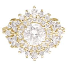 a gold ring with an oval cut diamond surrounded by smaller round and pear shaped diamonds