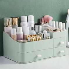 an organized makeup drawer is shown with cosmetics and other beauty products in the holder, along with a mirror