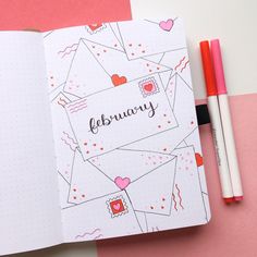 an open notebook with the word february written on it and two pencils next to it