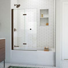 a bathroom with a white tiled wall and floor