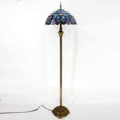 a floor lamp with a blue glass shade