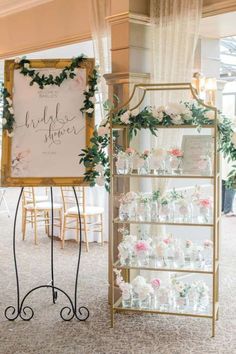 a sign that is on top of a stand in front of a table with flowers