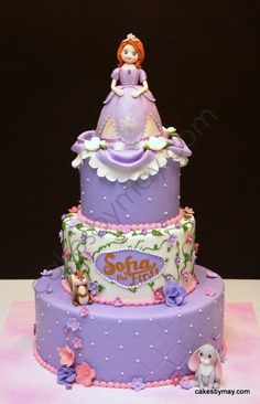 a purple and white cake with a princess on top