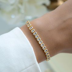 Super chic, emerald cut bezel set tennis bracelet featuring cubic zirconia stones. Looks absolutely gorgeous and high-end! Handmade with love, care and attention to detail! - - D E T A I L S - -  ▪︎ We use a Thick plating of 14k Gold or Rhodium over Brass  ▪︎ Available in Sizes: 6.25", 6.75" or 7"  ▪︎ Latch Closure ▪︎ Nickel-free, lead free and hypoallergenic ▪︎ Highest Grade CZ for an authentic diamond look! Unsure of your bracelet length? Use our Bracelet Sizer Tool! https://samijewels.etsy.com/listing/1782950827 Bracelets on Model 🎁 Comes in a gift-box, ready for gift giving!  ✈️ Ships same day for fast delivery!  ♡ Made with 100% Pure Love!  🥰 Happy to answer any questions you may have!  🤗 Let's Connect!  IG: samijewels_ Cubic Zirconia Channel Set Tennis Bracelet As Gift, Channel Set Cubic Zirconia Tennis Bracelet As A Gift, Elegant Wedding Tennis Bracelet With Channel Set, Diamond Bracelet With Handset Stones For Anniversary, Elegant Channel Set Tennis Bracelet For Weddings, Cubic Zirconia Channel Set Tennis Bracelet For Wedding, Wedding Bracelets With Channel Set Cubic Zirconia, Wedding Cubic Zirconia Diamond Bracelet With Bezel Setting, Formal Cubic Zirconia Tennis Bracelet With Handset Stones