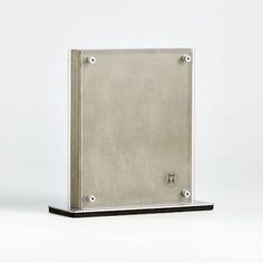 a metal box sitting on top of a white surface