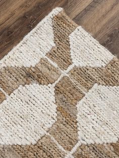 a brown and white rug on top of a wooden floor