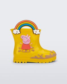 a child's rubber boot with a cartoon character on the side and a rainbow in the middle