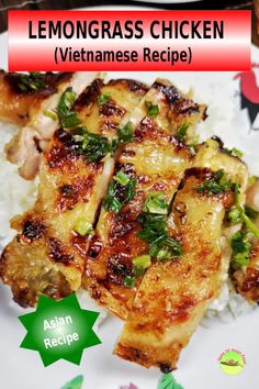 a plate topped with chicken and rice covered in green herbs next to a red sign