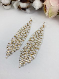 "Bridal beaded earrings, abstract white and gold seed beaded earrings, statement boho earrings, wedding jewelry Length 5\" including ear wire Width 1\" Made with best quality Japanese seed beads and 24k gold dipped seed beads Lightweight and unique extravagant style - designed and made by Luba Ro Colors used - glossy white and gold Select closure earwires leverbacks clip-ons (for non-pierced ears)" White Beaded Earrings With Gold Beads For Wedding, White Bohemian Jewelry With Dangling Beads, Gold Beaded Drop Earrings For Wedding, Gold Beaded Chain Earrings For Wedding, White Beaded Earrings With Round Tiny Beads, Gold Bohemian Beaded Earrings For Wedding, Elegant White Beaded Earrings With Tiny Beads, Gold Beaded Earrings For Wedding, Bohemian Gold Beaded Earrings For Wedding