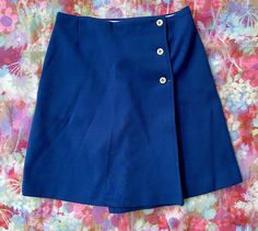 his listing is for a vintage 1960s 1970s navy blue with white buttons wrap skort by Alfred Dunner. This skort is so great and is in good vintage condition! Skort is navy blue and is giving a wrap min skirt vibe but is really a skort! Perfect for on and off the court! Material is a knit poly blend, cotton inner waist band. Skort shows only minor wear, nothing to note! Tag reads Alfred Dunner and is marked a size 12. Please check measurements for accuracy. Measurements: (please double where approp Mod Skirt, Three Witches, Wrap Skort, Button Skirt, Greensboro Nc, Alfred Dunner, Vintage 1960s, Waist Band, Labour Day