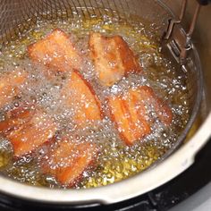 the food is being cooked in the pot on the stove top with water and oil