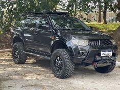 a black four - doored suv parked in the shade