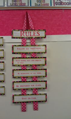 a bulletin board with pink and white polka dot trimmings on the back wall