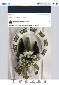 a christmas wreath with pine trees on it is displayed in front of a facebook page