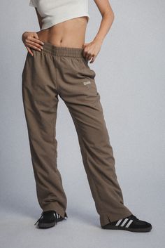 DUME PANT+100% NYLON+ LINED SPORT PANTS+ EMBROIDERED LOGO+ BACK POCKET+ ELASTIC WAIST*INSPIRED BY VINTAGE GARMENTS* Male model is 6'0 and is wearing a size Small. Female model is 5'6 and is wearing a size Small. Elwood Clothing, Nylon Pants, Female Model, Back Pocket, Season Colors, Sport Pants, Male Model, Brown Color, Casual Pants