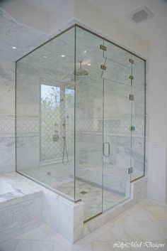 a walk in shower sitting inside of a bathroom