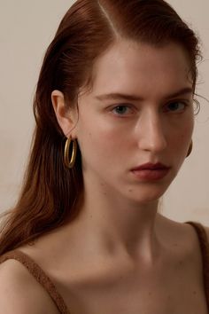 Gold-plated with a matte finish    Oval-shaped﻿    Diameter - 2" / 4cm along the longer side and 1" /3cm along the shorter side Matte Gold Hoop Metal Jewelry, Minimalist Oval Metal Hoop Earrings, Chic Gold Oval Hoop Earrings, Minimalist Metal Hoop Earrings Tarnish Resistant, Minimalist Tarnish Resistant Metal Hoop Earrings, Minimalist Tarnish-resistant Metal Hoop Earrings, Modern Matte Gold Brass Hoop Earrings, Classic Brass Hoop Earrings, Matte Gold Brass Hoop Earrings