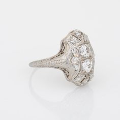 Elegant & finely detailed Belais Art Deco era ring (circa 1920s to 1930s) crafted in 14k white gold.   Two centrally mounted old European cut diamonds are estimated at 0.48 carats each. A further 8 old mine cut diamonds total an estimated 0.42 carats. The total diamond weight is estimated at 1.38 carats (I-J colour and VS2-I2 clarity).      Belais Brothers is a highly regarded and very collectible maker from the late 19th century to the early 20th century. The ring epitomises vintage charm and w Collectible Diamond White Platinum Diamond Ring, Collectible Platinum Diamond Ring With Brilliant Cut, Collectible Platinum Diamond Ring In Diamond White, Art Deco Brilliant Cut Diamond Ring Collectible, Art Deco Collectible Diamond Ring With Brilliant Cut, Platinum Diamond Ring With Diamond Cut For Collectibles, Platinum Collectible Diamond Ring, Classic Platinum Diamond Ring Collectible, Classic Collectible Diamond Ring With Center Stone