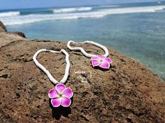 Aloha, beach lovers! 🌺 Dive into island magic with our Plumeria seashell necklace! Inspired by the vibrant beauty of the Hawaiian Islands, this charming accessory brightens up your everyday outfits, whether you're lounging by the waves or enjoying a sunset cocktail. Imagine wearing a stunning, handmade plumeria blossom that sparkles like sunlight on the ocean. Each flower is crafted with care, making every necklace uniquely yours! With whimsical seashell beads, this piece captures the essence of paradise and is sure to invite compliments wherever you go. Elevate your accessory collection with our Plumeria seashell necklace and let the spirit of the islands shine through in your everyday style! 🌟 Special Offer: Enjoy our BUY MORE, SAVE MORE ON SHIPPING deal! 😄 Please note that colors may Sunset Cocktail, Necklace Seashell, Hawaiian Necklace, Hawaiian Jewelry, On The Ocean, Seashell Jewelry, Seashell Necklace, Hawaiian Islands, Beach Lovers