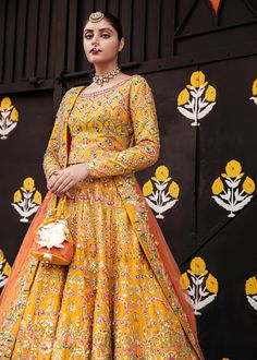 Pakistani Bridal Yellow Orange Lehenga Choli is a traditional masterpiece to wear on any wedding festivity, especially Mehndi or Mayun. The vibrant shade of this Lehenga Choli makes it an alluring choice for the Bride. Hand-crafted adornments and designs make this Mehndi Dress an epitome of beauty and royalty. Choli: Bridal choli in the bright yellow shade is gracefully emblazoned with hand-crafted details of sitara and pearls. The fully embellished choli is adorned with lavish designs and fine Traditional Dola Silk Wedding Gown, Traditional Wedding Gown In Dola Silk, Traditional Wedding Dola Silk Gown, Traditional Drape Gown With Dori Work For Ceremonies, Traditional Gown With Multicolor Embroidery For Reception, Anarkali Gown For Traditional Ceremonies With Dori Work, Anarkali Gown With Dori Work For Traditional Ceremonies, Traditional Gown With Dori Work For Reception, Traditional Art Silk Wedding Gown