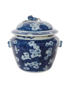 a blue and white covered jar with flowers on the lid is sitting in front of a white background