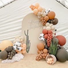 an arch made out of balloons and rocks