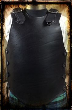 "This plain breastplate is made of 8-9 oz vegetable tanned leather and is hand dyed solid black. A buckle and strap allow for each shoulder piece to be adjusted for chest size, while the torso has d-rings on leather tabs hat allow for tight and easy lacing with nylon boot laces...quite adjustable for a wide range of sizes from 39\" in the chest and torso. This armor will shop via UPS due to the larger package size. Ohio residents are to pay 6.5% sales tax." Black Breastplate, Leather Breastplate, Boot Laces, Shoulder Piece, Leather Bracers, Quality Hats, Layered Cuts, Plain Black, Leather Patches