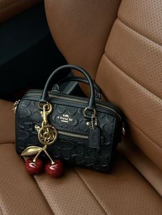 Coach Bags Handbags Black, Coach Aesthetic Bag, Coach Bag With Cherry Charm, Cherry Bag Charm, Coach Handbags Outfits, Coach Cherry Charm, Black Bags Aesthetic, Coach Bah, Coach Cherry Bag