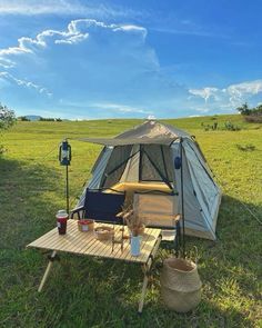 a tent set up in the middle of a field