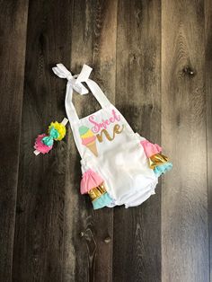 "This adorable romper is perfect for your princess' first birthday outfit. It makes a great photo prop for birthday invitations or to pictures just to remember this special day!! The romper has straps that untie so you can lower or raise the outfit for a better fit. The back of the romper has layers of ruffle and the top of the ruffles is embellished with a gold bow. If you would like a different color bow, please message me with the color that you would like. The headband is made to fit the siz Sweet Pink Bubble Romper For Birthday, Cute Pink Bubble Romper For Cake Smash, Playful Pink Bubble Romper For Cake Smash, Sweet Cotton Bubble Romper For First Birthday, White Bubble Romper For Spring Cake Smash, White Bubble Romper For Cake Smash In Spring, White Cute Bubble Romper For First Birthday, Cute White Bubble Romper For First Birthday, Sweet White Bubble Romper For First Birthday