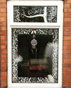 the window is decorated with christmas decorations