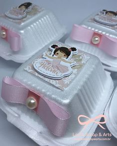 three little white boxes with pink bows and pearls on the top one has an image of a ballerina on it