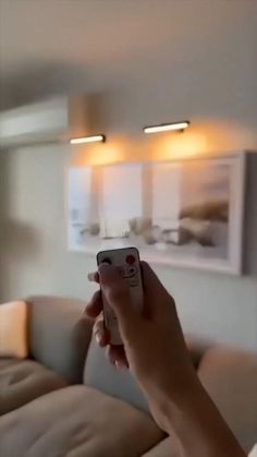 a person holding a remote control in their hand