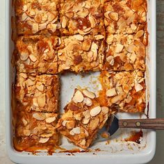 a pan filled with sliced almond bars on top of a table