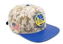 the golden state warriors camo and blue snapback hat has an american flag on it