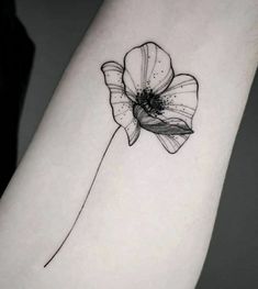 a single flower tattoo on the arm