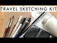 travel sketching kit with pens, ink and water bottle on the table next to it