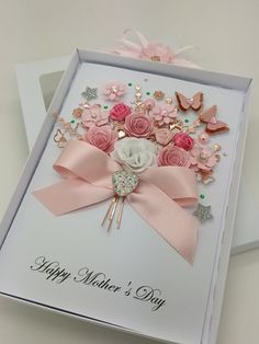 a mother's day card with pink flowers and butterflies on the front in a white box