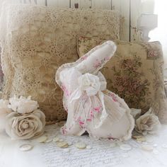 a pair of slippers sitting on top of a table next to pillows and flowers