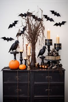 a dresser with candles and halloween decorations on it