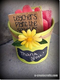 a teacher's plant pot with flowers and notes on it