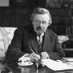 a man sitting at a table with a pen and paper