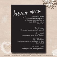 the wedding menu is displayed on a card with white flowers and black paper in front of it