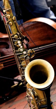 a saxophone sitting on top of a brick floor