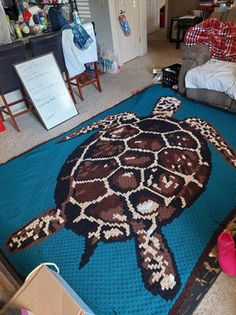 a large turtle rug is on the floor in a room with furniture and other items